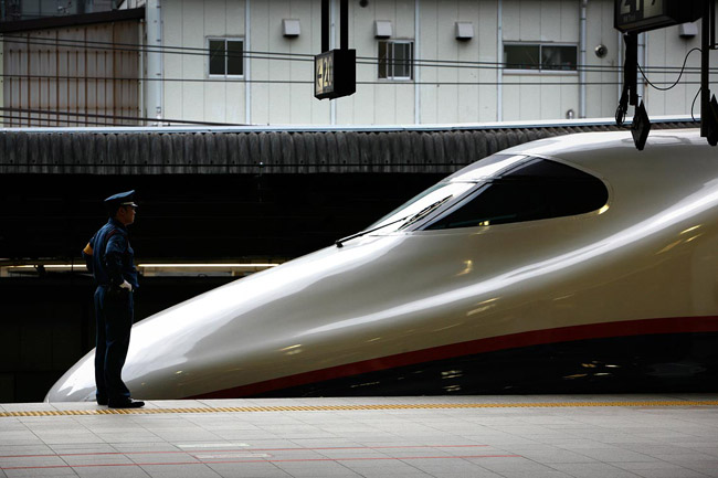 Station master checking on a Shinkansen, superfast bullet train